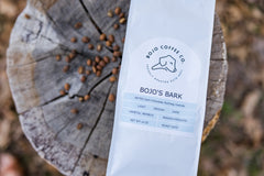 Angled close view of the BoJo Bark label against a stump
