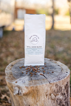 Wider outdoor view of the Still Good Blend bag beside a tree