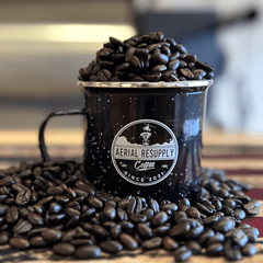 Aerial Resupply mug filled with dark roasted coffee beans