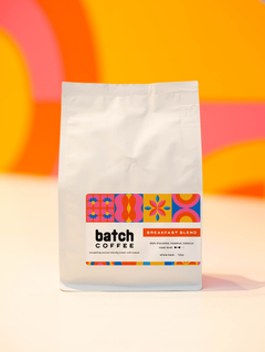 Batch Coffee Breakfast Blend bag against an orange and pink background