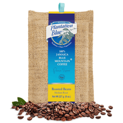 Plantation Blue 8 oz medium whole-bean Jamaica Blue Mountain coffee bag with loose roasted beans at its base