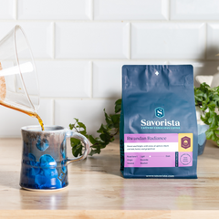 Rwandan Radiance bag beside a mug and kitchen plant