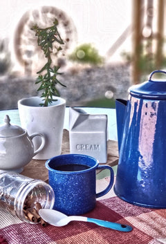 Blue enamel coffee pot and cups arranged outdoors — Al Gusto Cowboy Blend Medium-Dark Coffee