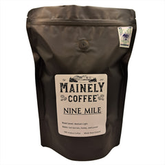 Black Mainely Nine Mile bag with a white rectangular label on a white background