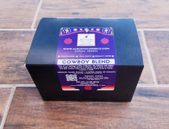 Black Cowboy Blend pod box on a wooden table — Al Gusto Cowboy Blend Medium-Dark Coffee