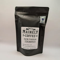 Black Northern Terminus coffee pouch with Mainely branding and a white label