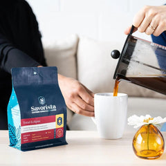 Pouring French-press coffee beside a Total Eclipse bag