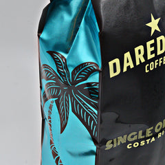 Angled detail of palm artwork on Costa Rica coffee bag