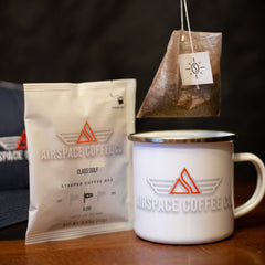 Airspace Class Golf packet and steeping bag above a mug