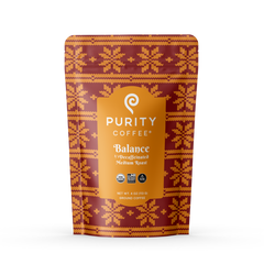 Purity Balance coffee bag with orange and purple patterned packaging