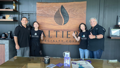 Bean & Bean Altieri Mima Estate Washed Gesha Coffee — four people standing beside a wooden Altieri sign