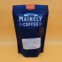 Blue Mainely Cribworks coffee bag with its white blend label on yellow