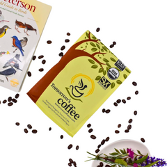 Yellow Tomorrow’s Coffee bag with scattered beans, a book and flowers — Tomorrow’s Coffee Organic Espresso Blend gallery