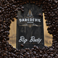 Big Body bag arranged among roasted coffee beans