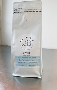 BoJo Kenya coffee bag standing on a metal surface