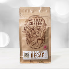 Kitty Town Delilah’s Brazilian Dark Roast Decaf Coffee — 12 oz coffee bag standing on a kitchen counter