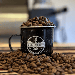 Aerial Resupply mug filled with medium roasted coffee beans