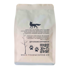 Back of a white Foxen Coffee pouch with fox logo and QR code