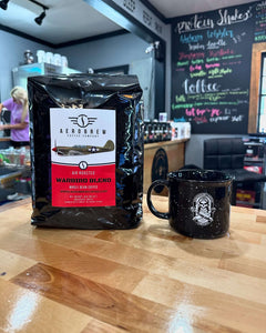 Warbird bag and mug on a café counter