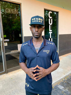 Person wearing a cap outside a building on the Dope Coffee page