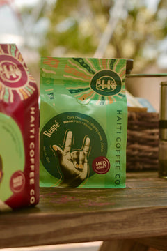 Respè coffee bag displayed with other coffee packages on a wooden surface
