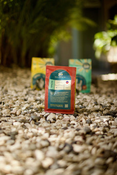 Kafe Dondon rear information panel shown on a red pouch in the outdoor display