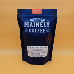 Mainely Mattagamon Guatemalan coffee in a blue bag on a yellow background