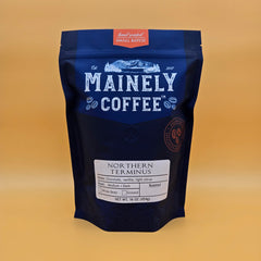 Blue Mainely Northern Terminus blend bag on a mustard-yellow background
