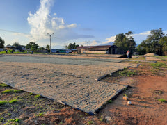 Outdoor coffee drying patio at the Sangareni cooperative