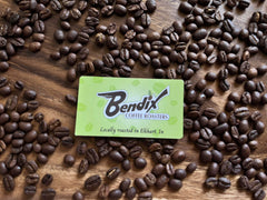 Bendix business card surrounded by roasted coffee beans on wood — Bendix Peppermint Flavored Coffee gallery
