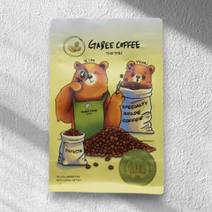 GABEE bear-illustrated coffee packaging in sunlight