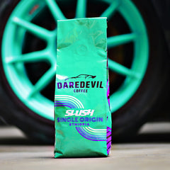 Daredevil SLUSH Ethiopia bag beside turquoise car wheel