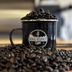 Aerial Resupply mug filled with dark roasted coffee beans