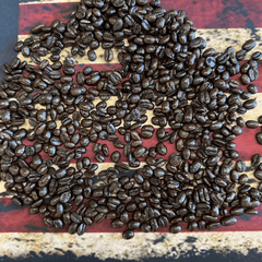 Dark roasted coffee beans on an American flag background