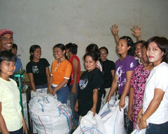 Group of people gathered indoors beside coffee sacks — Tiny Footprint Sumatra Takengon Select Dark Roast