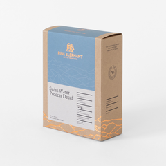 Angled front view of Pink Elephant Swiss Water Decaf packaging with a blue panel