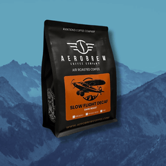 Slow Flight Decaf bag against a blue mountain background