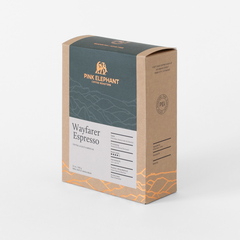 Angled front view of Pink Elephant Wayfarer Espresso packaging with a charcoal panel