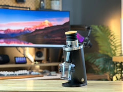 Black Turin DF54 compact grinder displayed on a coffee bar
