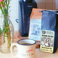 Background Actor hazelnut coffee with mug and grinder