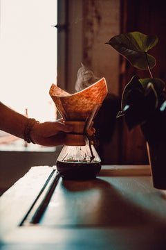 Hand holding a paper filter over a Chemex pour-over brewer — Clear Lake 6 Bean Dark Roast Coffee Blend gallery