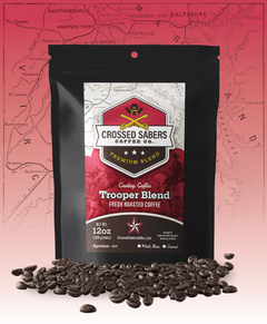 Crossed Sabers Trooper Medium & Dark Roast Blend bag with scattered beans against a pink-red map backdrop
