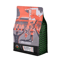Matchday bag with orange street-scene artwork at an angle — Kickoff Matchday Peru Light Roast Coffee, 12 oz