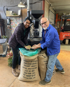 Two people standing beside a coffee sack in a roastery — Hemisphere Ethiopia Lekempti Washed Light Roast, 12 oz