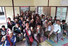 People gathered on benches inside a community room — Myanmar Myin Dwin Natural Coffee, 5 lb gallery