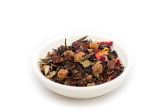 Bombshell Breeze loose-leaf tea with fruit pieces and flower petals in a white bowl
