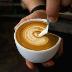 Passport Siena Medium Roast Espresso Coffee — hand drawing a swirl in a cup of latte