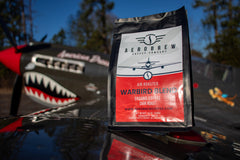 Warbird coffee bag beside aircraft nose artwork