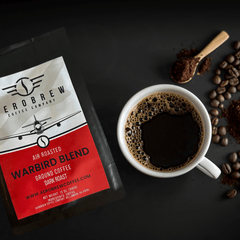 Warbird bag beside brewed coffee and a bean scoop
