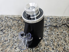 Top angled view of the DF54 adjustment dial, chute and dosing cup